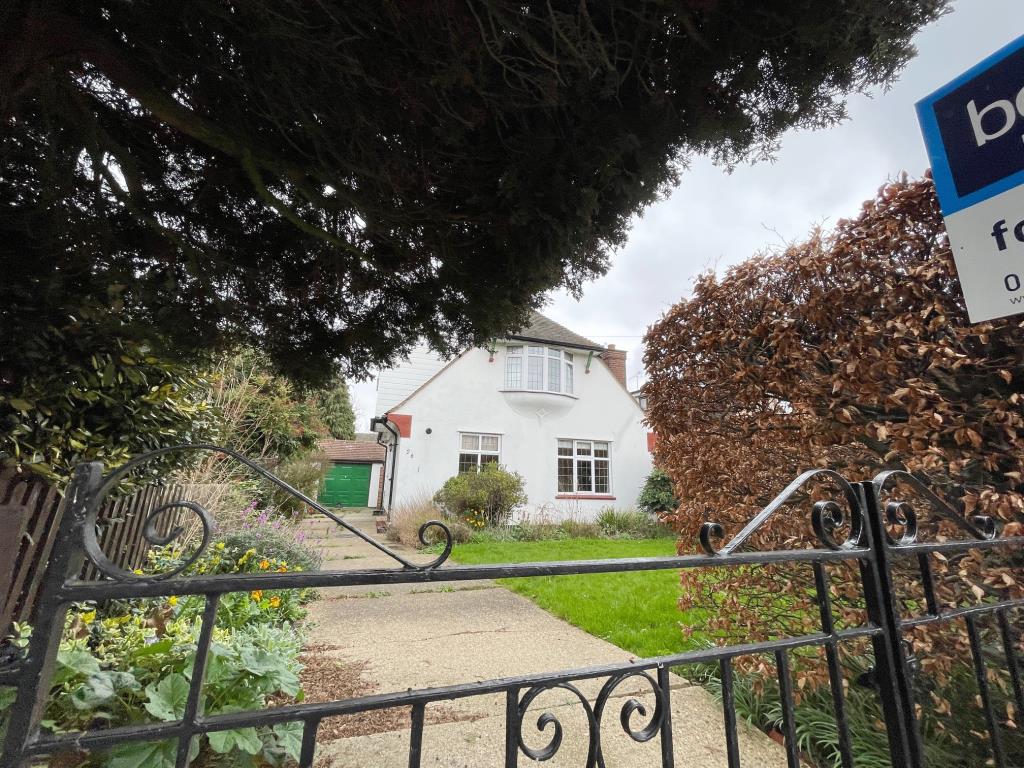 Lot: 63 - A DETACHED THREE-BEDROOM HOUSE SITUATED IN A POPULAR LOCATION FOR IMPROVEMENT - Front of property with gates